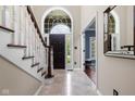Bright foyer features tile floors, elegant staircase, and large window over the front door at 7126 Nile Ridge Ct, Indianapolis, IN 46236