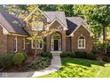 Inviting brick home featuring a stylish arched entryway and well-manicured landscaping at 7126 Nile Ridge Ct, Indianapolis, IN 46236