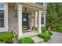 Welcoming front porch with black door and decorative details at 7319 Hartington Pl, Indianapolis, IN 46259