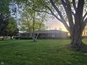 View of single story home with mature trees at 7622 Eaker Ct, Brownsburg, IN 46112