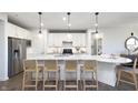Modern kitchen featuring white cabinetry, stainless steel appliances, and a large center island at 8436 Paxton Dr, Brownsburg, IN 46112