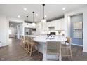 Spacious kitchen with a large island featuring pendant lighting, seating, and modern appliances at 8436 Paxton Dr, Brownsburg, IN 46112
