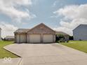 Lovely single-story home featuring a three-car garage, basketball hoop, and paved driveway at 845 Blackberry Dr, Greenwood, IN 46143