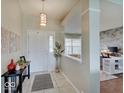 Bright foyer featuring tile flooring, an eye-catching light fixture, and elegant decor at 845 Blackberry Dr, Greenwood, IN 46143