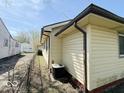 The side of the house has an air conditioning unit and a view of the adjacent property at 907 W 14Th St, Muncie, IN 47302