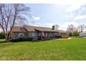 Beautiful brick home with a lush green lawn, mature trees, and a welcoming front porch at 9377 N 500 W, McCordsville, IN 46055