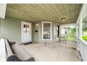 Relaxing front porch featuring a bench, chairs, and stylish overhead lighting, perfect for outdoor enjoyment at 1114 Pennsylvania St, Columbus, IN 47201