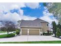 Spacious three-car garage with a basketball hoop, adjacent to a beautifully landscaped yard at 11233 Rockingham Cir, Fishers, IN 46037