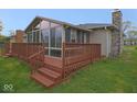 Spacious wooden back deck with a privacy fence and access to a sunroom at 1314 Brookside S Dr, Columbus, IN 47201