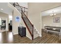 Inviting foyer with hardwood floors, staircase with wood railing, and views into the dining area at 13728 Oliver Ln, Carmel, IN 46074