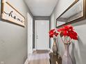 View of the charming hallway with decor, lighting, and a wooden 'home sweet home' sign on the wall at 1401 E 24Th St, Muncie, IN 47302