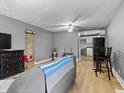 Bright living room featuring hardwood floors and a view to the kitchen at 1401 E 24Th St, Muncie, IN 47302