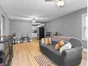 Open-concept living room featuring neutral walls and wood-look flooring at 1401 E 24Th St, Muncie, IN 47302