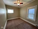 Cozy bedroom with neutral carpet, and two windows allowing for plenty of natural light at 1401 W 34Th St, Indianapolis, IN 46208