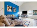 Bright living room boasts high ceilings, large sectional sofa, and colorful decor at 1666 Huntzinger Blvd, Pendleton, IN 46064