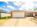 Spacious two-car garage with an extended driveway on a charming red brick house at 1823 E 44Th St, Anderson, IN 46013