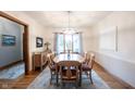 Sunlit dining room features a large window, elegant chandelier, and a classic wooden dining set at 1893 Water Oak Way, Avon, IN 46123