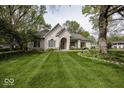 Charming home with manicured lawn, mature trees, and an inviting entrance at 1920 E 81St St, Indianapolis, IN 46240