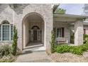 Inviting front porch with brick archway, bench swing, and attractive landscaping at 1920 E 81St St, Indianapolis, IN 46240
