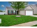 Well-manicured front lawn with a lovely tree, green shutters, and a brick and siding exterior at 2260 Quarter Path Rd, Cicero, IN 46034