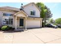 Charming two-story home with a two car garage, front porch, neutral siding, and a well maintained driveway at 2277 Grand Fir Dr, Greenwood, IN 46143