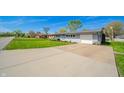 Well-kept single-story home with a long driveway and green lawn at 231 N East St, Pendleton, IN 46064