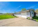 Single-story home with an attached garage and a well-kept driveway at 231 N East St, Pendleton, IN 46064