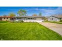 Attractive single-story home with well-maintained lawn, plantings, and driveway at 231 N East St, Pendleton, IN 46064