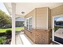 Charming covered porch with brick accents and white railing, providing a cozy outdoor space at 2342 Sheek Rd, Greenwood, IN 46143