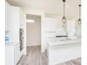 Bright, modern kitchen features white cabinets, island with sink, and stainless steel appliances at 2717 Penn Ave, Plainfield, IN 46168