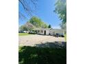 View of the house with large garage, driveway with vehicle, and well maintained lawn at 2871 N Talley Rd, Columbus, IN 47203