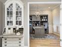 Elegant office space with custom built-ins, patterned wallpaper, and a comfortable workspace at 3387 Keystone Pass, Plainfield, IN 46168