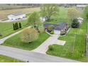 Sprawling aerial view of a home with a large yard, outbuildings, and a long driveway at 3710 E 750 S, Lebanon, IN 46052