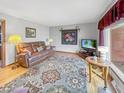 Cozy living room with plush leather seating, hardwood floors, and a bright window view at 3710 E 750 S, Lebanon, IN 46052