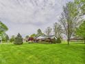 Expansive front yard view showcasing the home's landscaped lawn and mature trees at 3824 Oakwood Blvd, Anderson, IN 46011