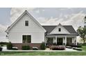 Inviting one-story home featuring white siding, a gray roof, brick foundation, and a cozy front porch at 3932 Besbie Way, Bargersville, IN 46106