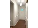 Bright hallway with white walls, wood-look floors, and a front door with decorative glass pane at 4212 Foxglove Trce, Indianapolis, IN 46237