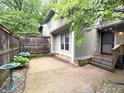 Charming side exterior featuring a private patio area, decorative accents, and a serene, garden-like atmosphere at 4212 Foxglove Trce, Indianapolis, IN 46237