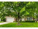Beautiful two-story home with a brick facade, two-car garage, manicured lawn, and mature trees at 4227 Short Ter, Carmel, IN 46033