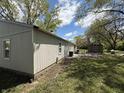 Spacious backyard with mature trees, patio area, and storage shed at 4456 N Kenyon Dr, Indianapolis, IN 46226