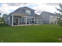 Spacious backyard with a covered patio perfect for entertaining and relaxation at 4518 W Meadows Ln, New Palestine, IN 46163
