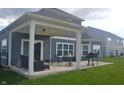 Cozy covered patio with string lights, outdoor furniture, and a grill for outdoor enjoyment at 4518 W Meadows Ln, New Palestine, IN 46163