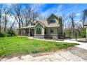 Charming exterior elevation of the home featuring a large porch and lush green lawn at 5386 W 1100 N, Fountaintown, IN 46130