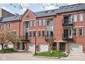 Brick townhomes with private garages and balconies offer an inviting curb appeal at 548 Lockerbie N Cir, Indianapolis, IN 46202