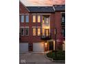 Attractive brick townhome with a private balcony and well-manicured landscaping at 548 Lockerbie N Cir, Indianapolis, IN 46202