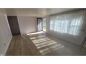 Bright living room with hardwood floors, large window, and modern front door at 5831 Aho Dr, Avon, IN 46123