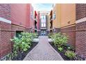 Condo complex pathway with brick and landscaping leading to the main entrance of the building at 622 E 10Th St # 312, Indianapolis, IN 46202