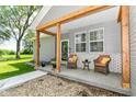 Cozy front porch with seating, decorative pillows, and a natural wood beam overhead at 6301 Prospect St, Indianapolis, IN 46203