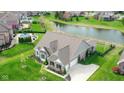 Stunning aerial view of the home, highlighting its spacious backyard and pond at 6784 W May Apple Dr, McCordsville, IN 46055