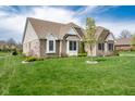 Brick home with green lawn and view of lake at 6784 W May Apple Dr, McCordsville, IN 46055